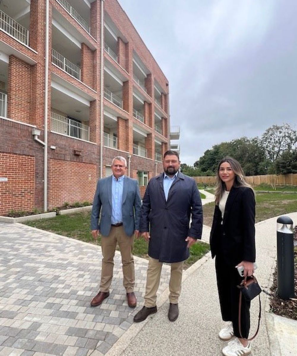 Cllr Guzel standing outside Reardon Court