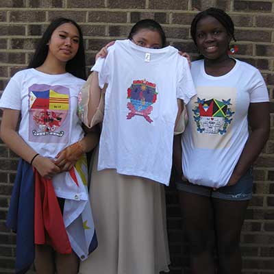 Students displaying t-shirts with their own heraldic designs