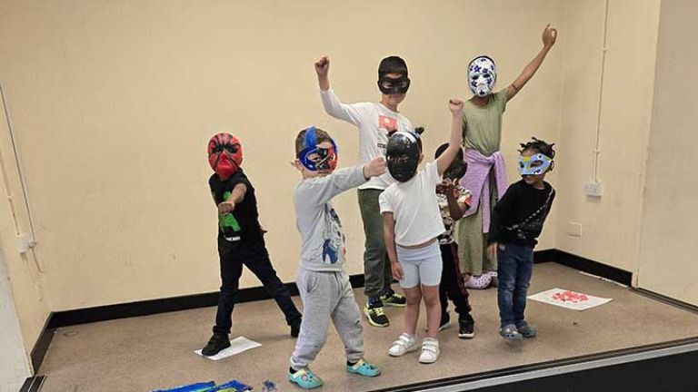 Children wearing their mask creations