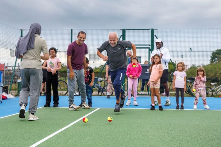 People playing games on a tennis court