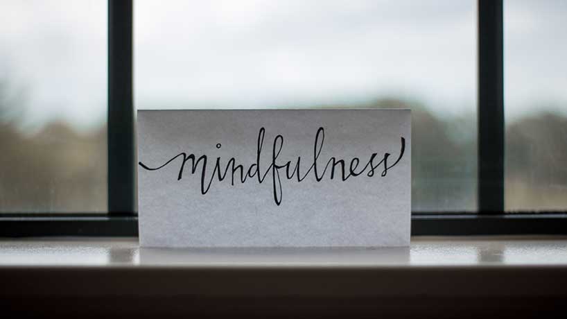 The word mindfulness written on a piece of paper