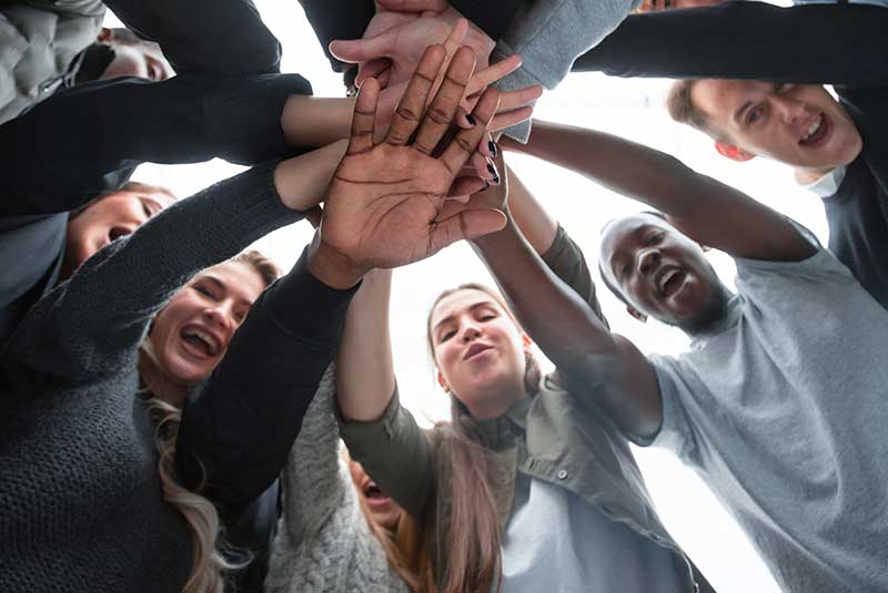 Teenagers joining hands