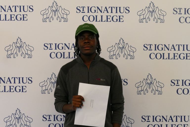 Boy from St. Ignatius College holding his exam results