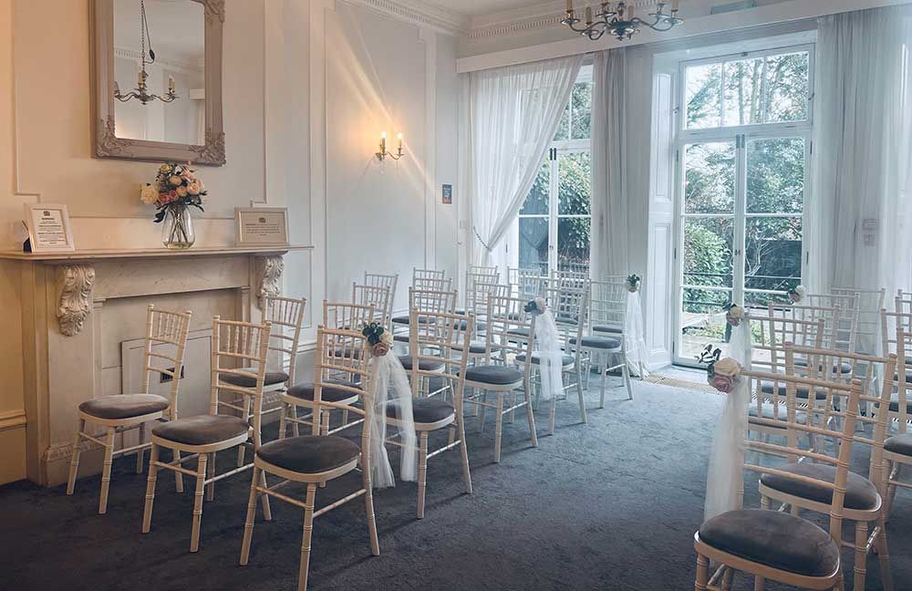 Admiral's Suite room with chairs looking towards the glass doors at the rear of the room