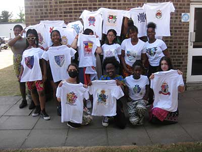 Students displaying t-shirts with their own heraldic designs