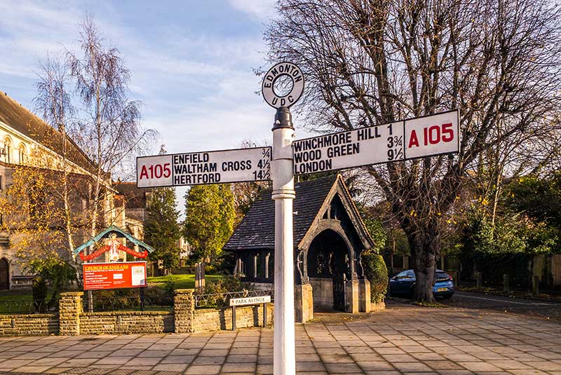 Road direction sign in front of church